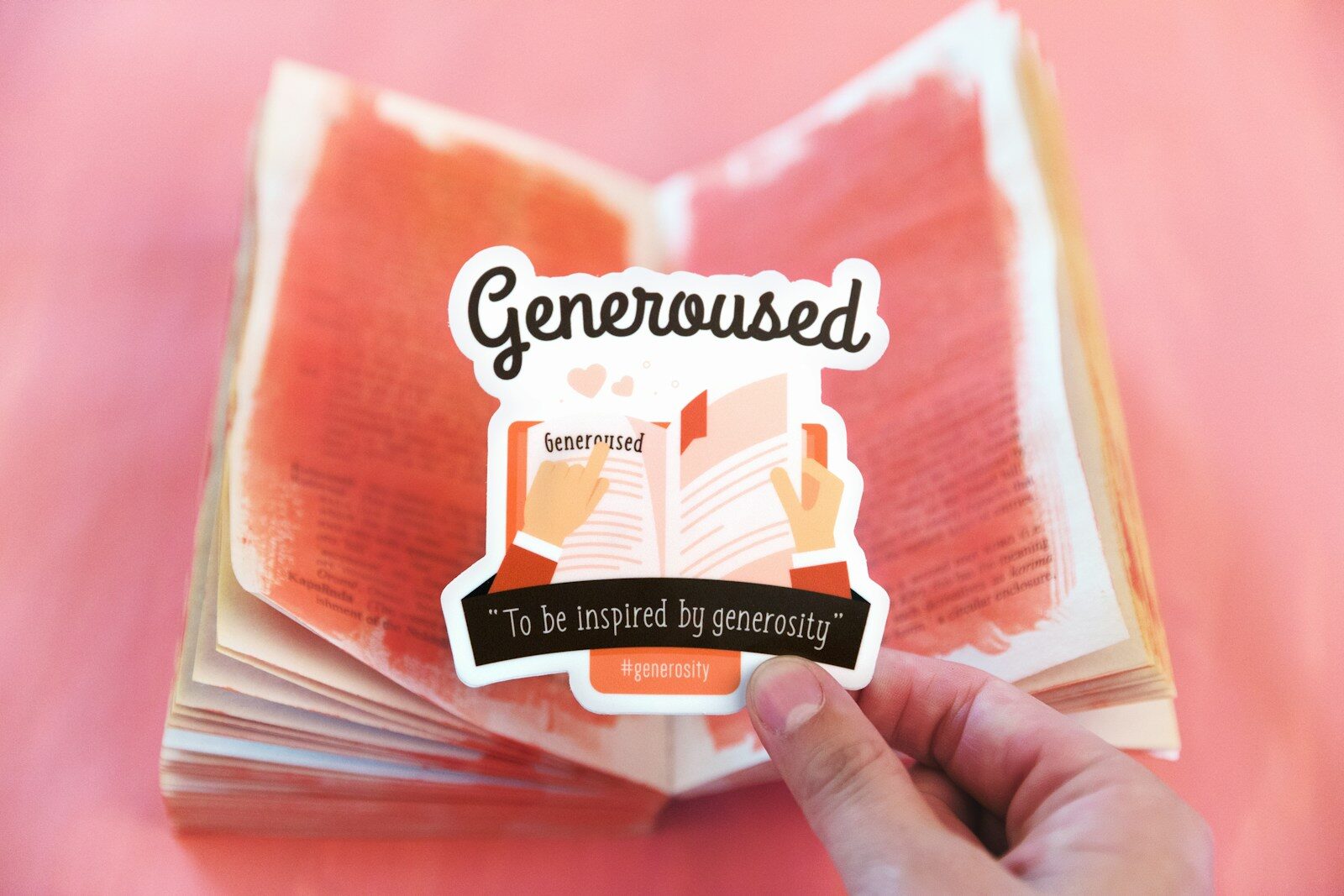 human hand holding Generoused card, designed by Franchesca of Unsplash team.